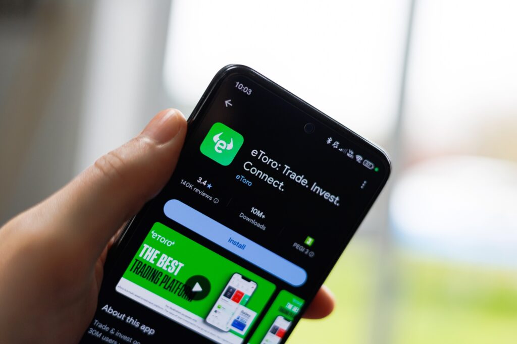 Person downloading the eToro mobile application